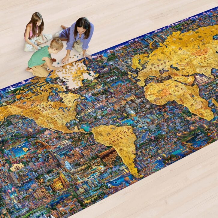 Three people assemble Costco's 60,000-piece puzzle of a world map