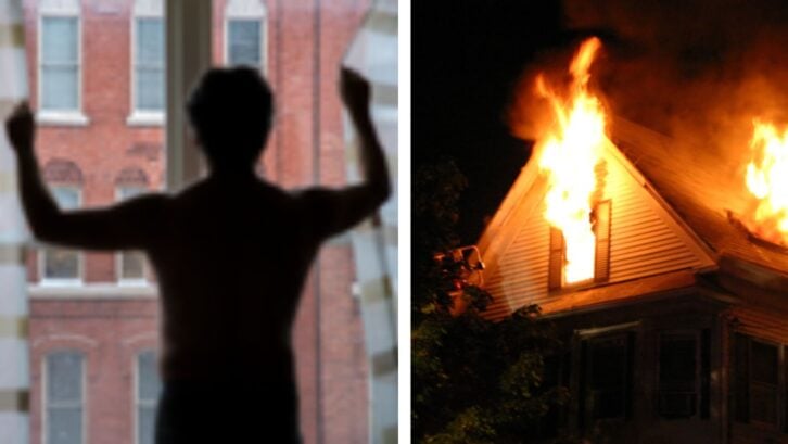 Shirtless man in front of window, a house on fire