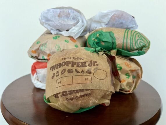 7 burger king burgers stacked next to each other