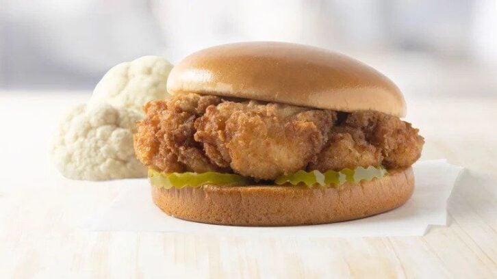 fried cauliflower on a bun with pickles