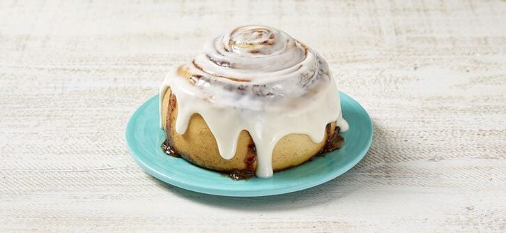 cinnabon cinnamon roll on a blue plate