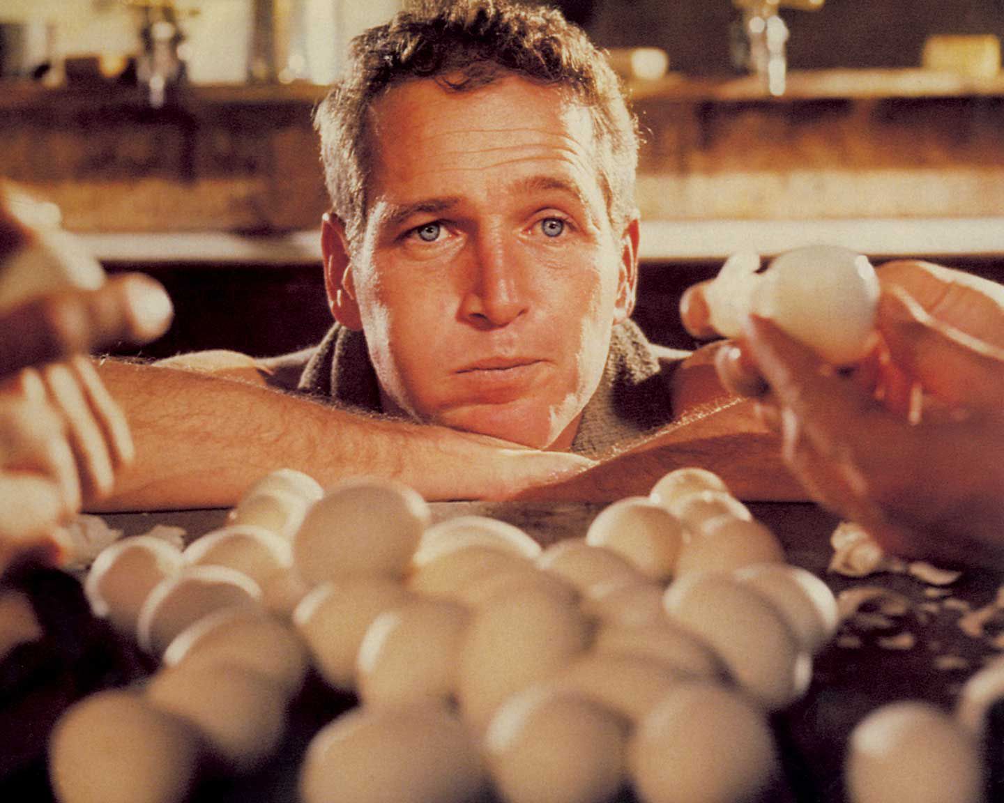 American actor Paul Newman (1925 - 2008) as Luke, attempting to eat fifty hard-boiled eggs in an hour in the film 'Cool Hand Luke', 1967.