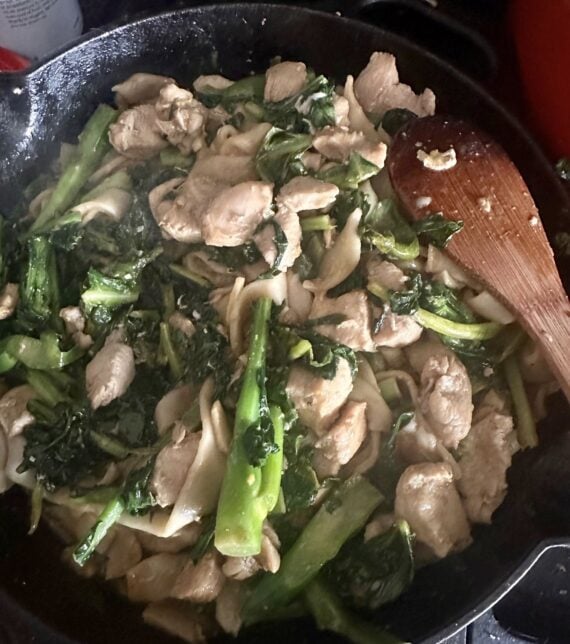 pan of pad see ew with wooden spoon