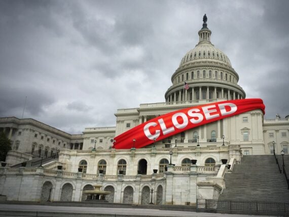 United States capitol building draped with banner that reads 'Closed'