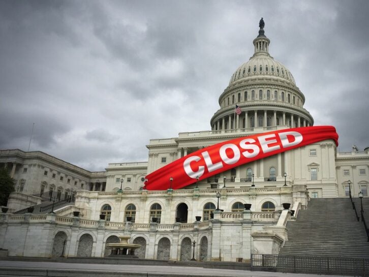 United States capitol building draped with banner that reads 'Closed'