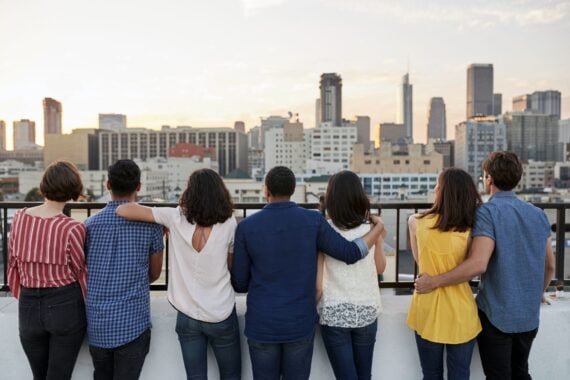 couples looking at view of city skyline from roof