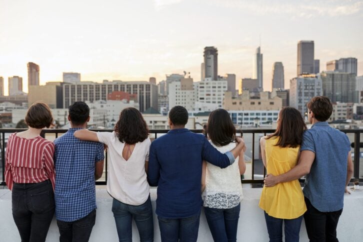 couples looking at view of city skyline from roof