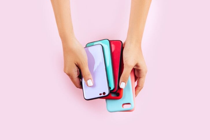 hands holding colorful smartphone cases
