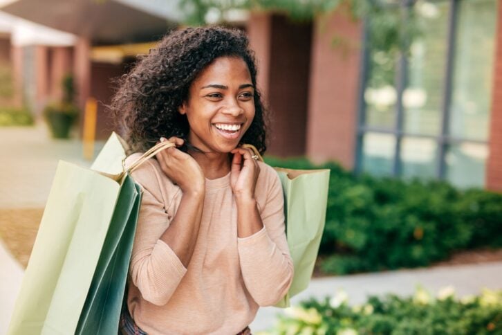 student carrying shopping bags