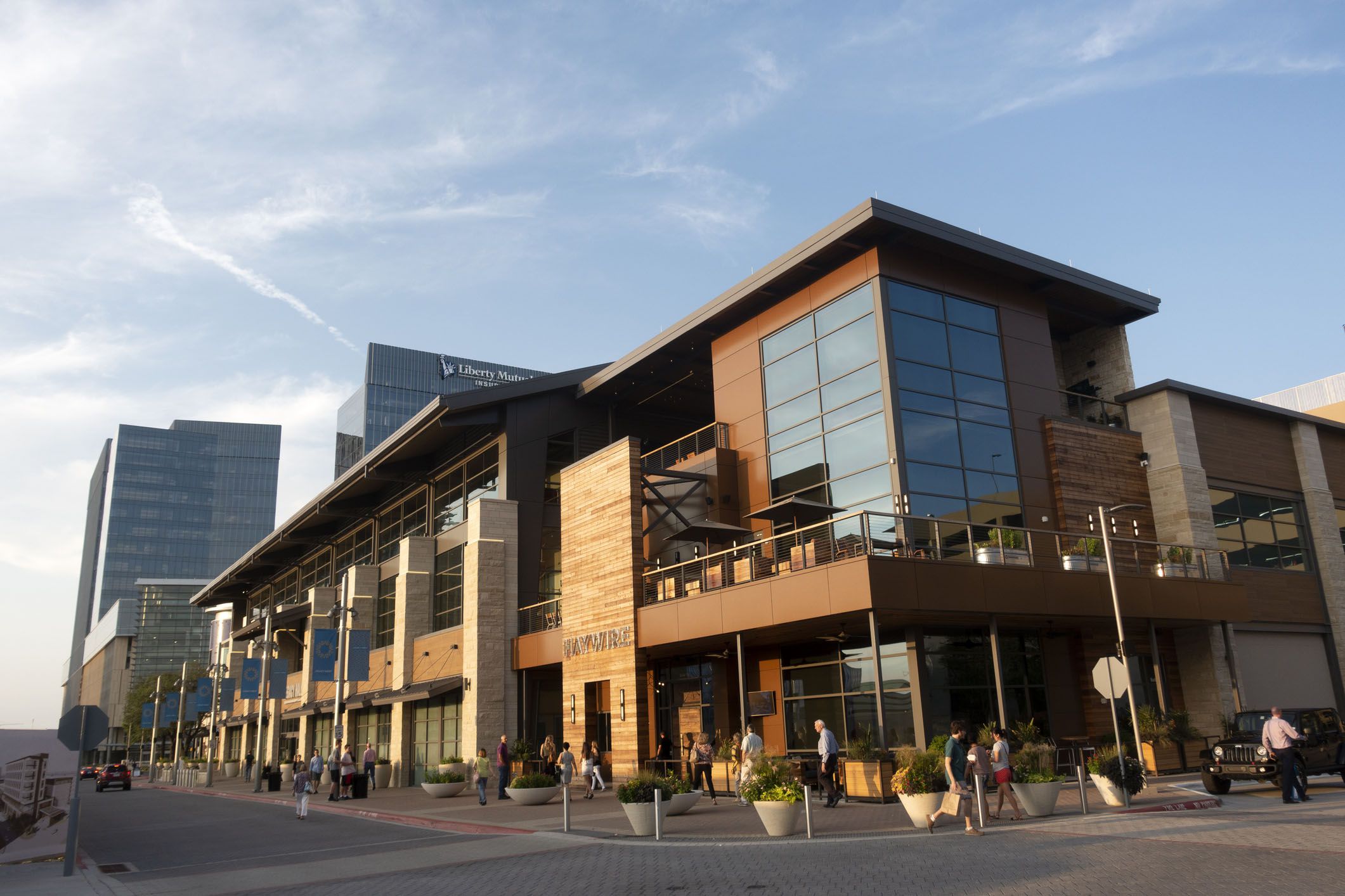 people walking on sidewalk at legacy west development in plano, texas