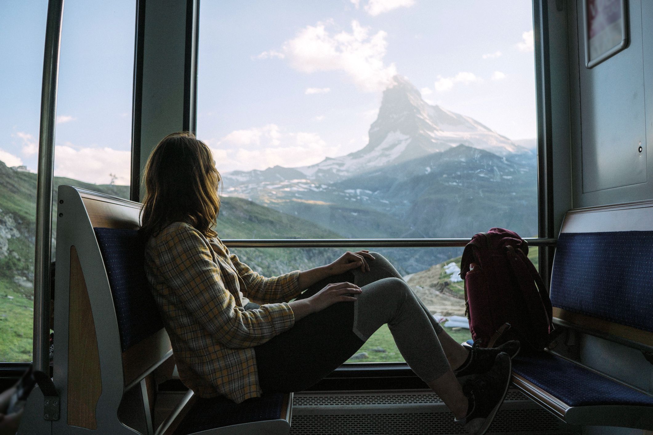 woman traveling on the train near matterhorn, swiss alps