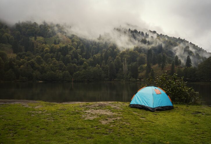 Camping tent in pine tree forest by the lake near Artvin, Turkey