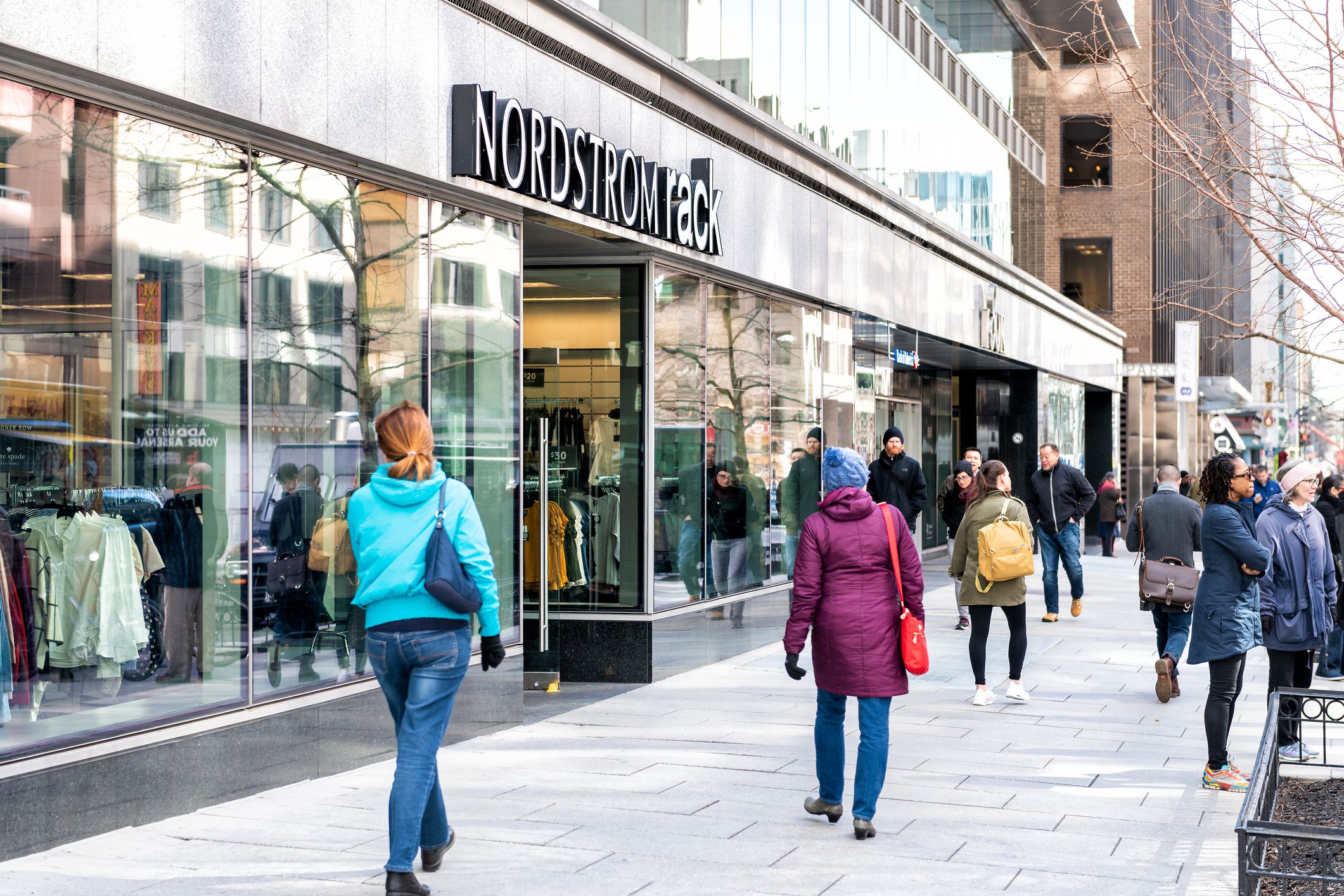 Washington DC, USA - March 9, 2018: Nordstrom rack store sign entrance shop in capital city street exterior, people walking on sidewalk