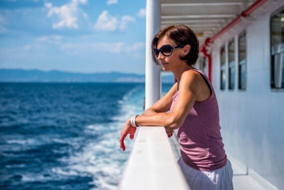 woman looking off deck on cruise ship