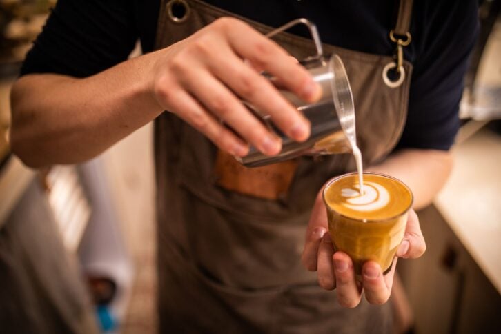 Barista make coffee cup latte art