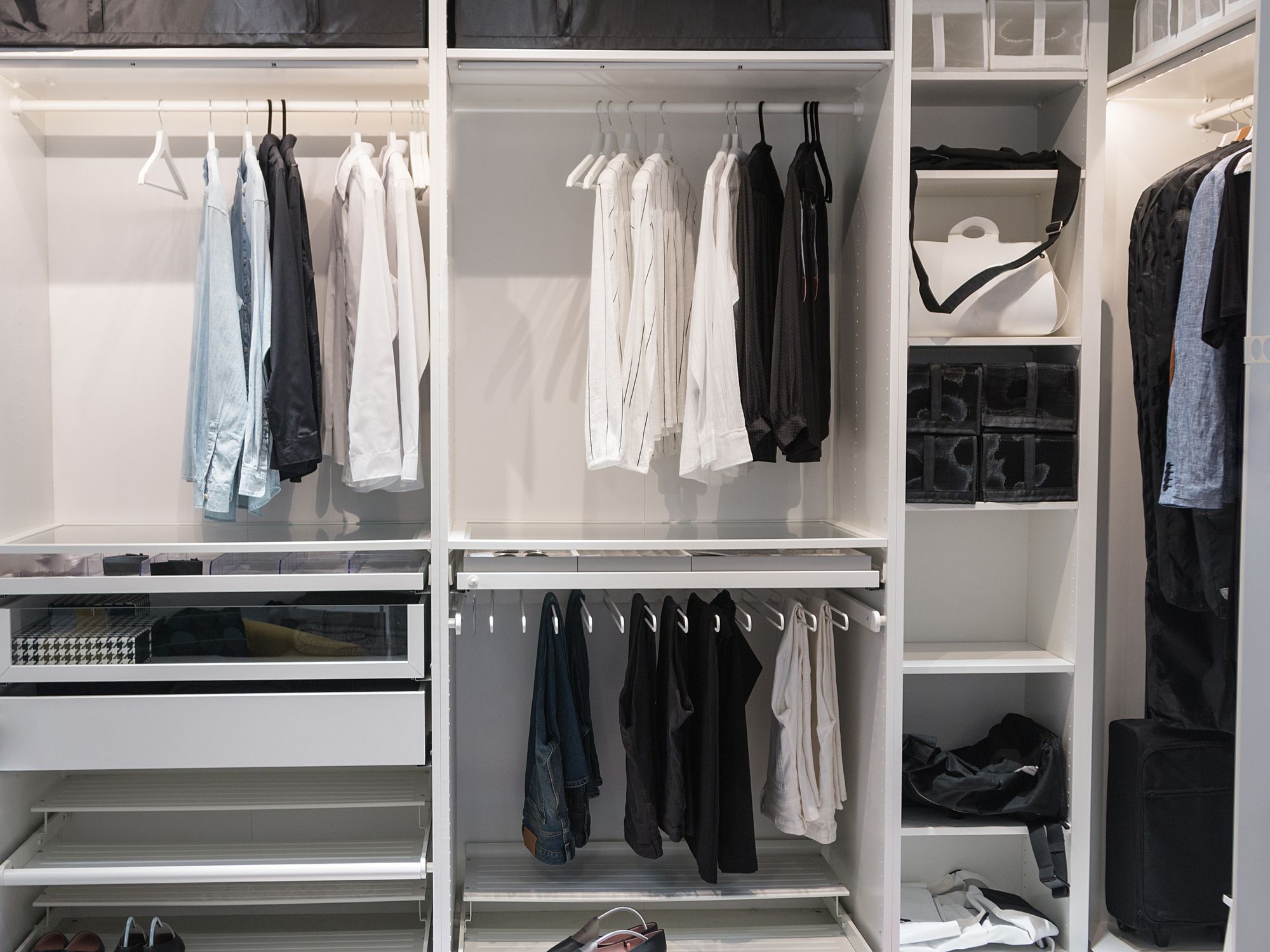 A well-organized closet. All things in their places, in boxes. Capsule wardrobe. Storage system.