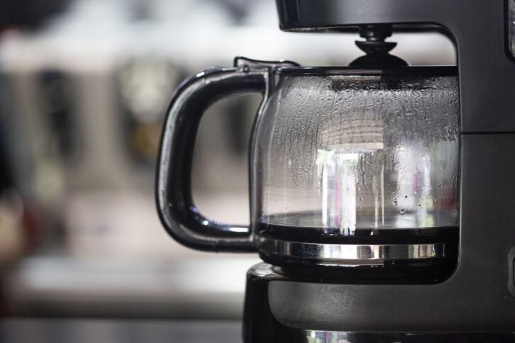 coffee maker with kitchen blurred in the background