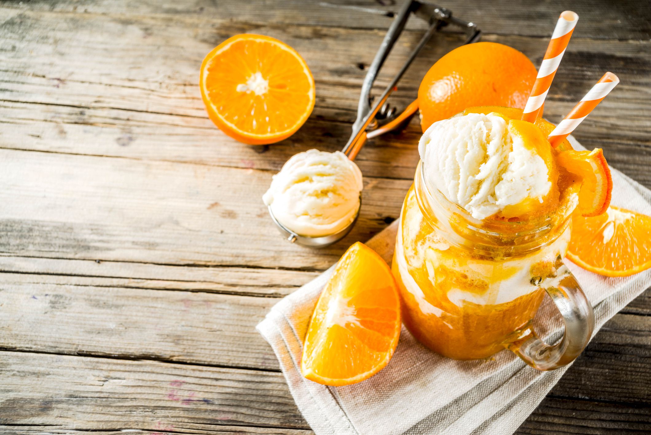Orange Soda Creamsicle cocktail. Ice Cream and orange smoothie. Dreamsicle drink. Rustic wooden background copy space