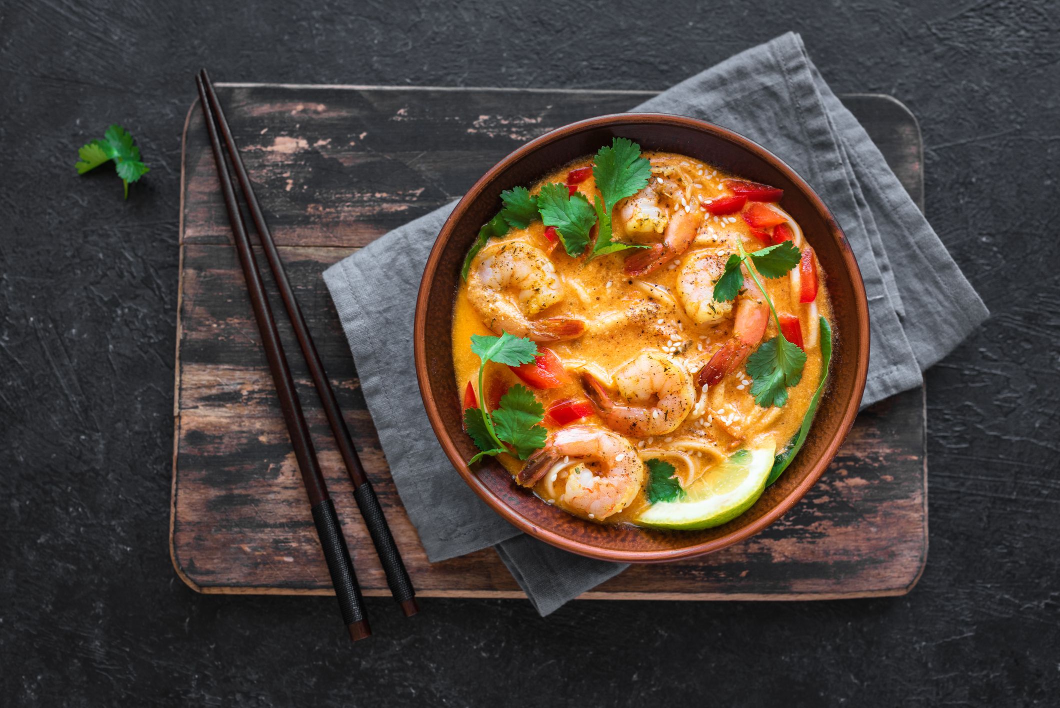 Laksa Shrimp Soup. Prawn noodle laksa soup on black background, top view, copy space. Asian Malaysian food.