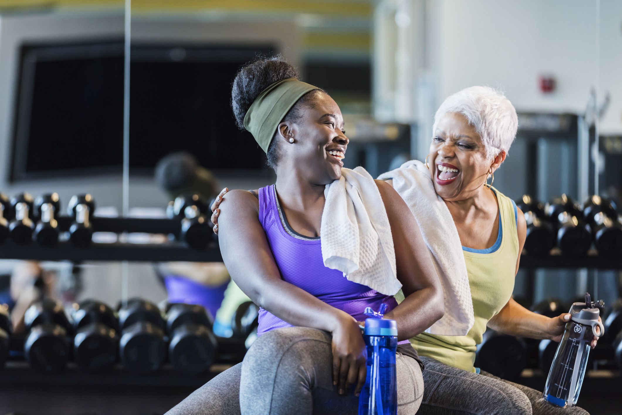 two women at gym laughing