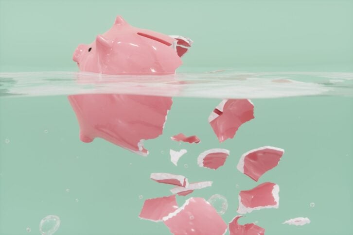 Shattered piggy bank in the water.