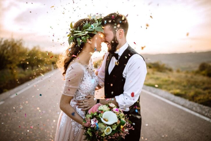 wedding couple happy, standing in middle of road