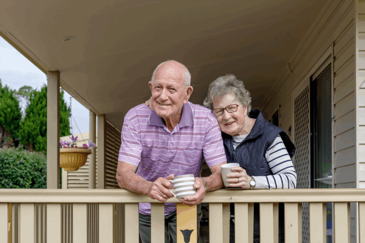 senior couple on the porch of a house