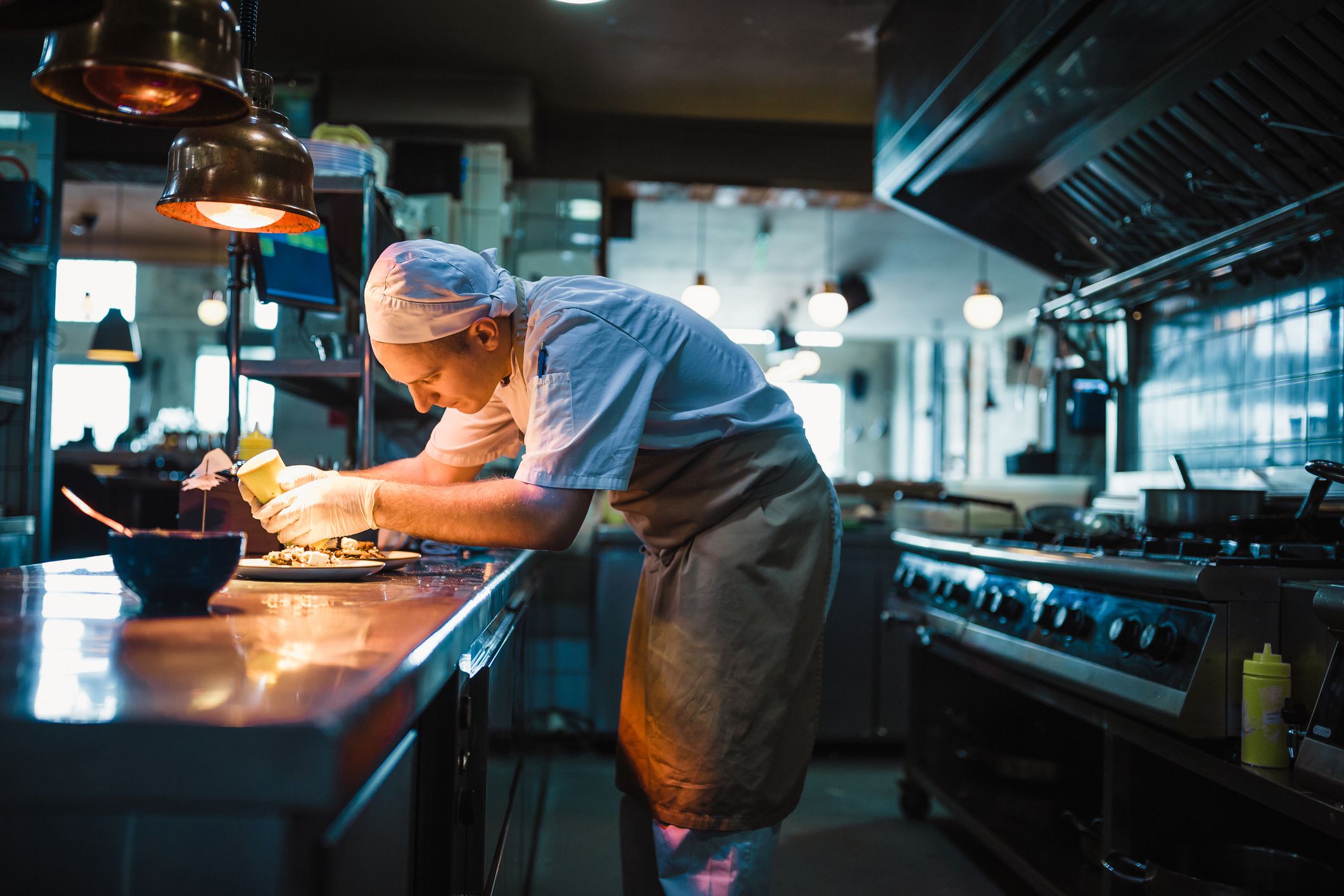chef serving food in the modern kitchen in a high-end restaurant