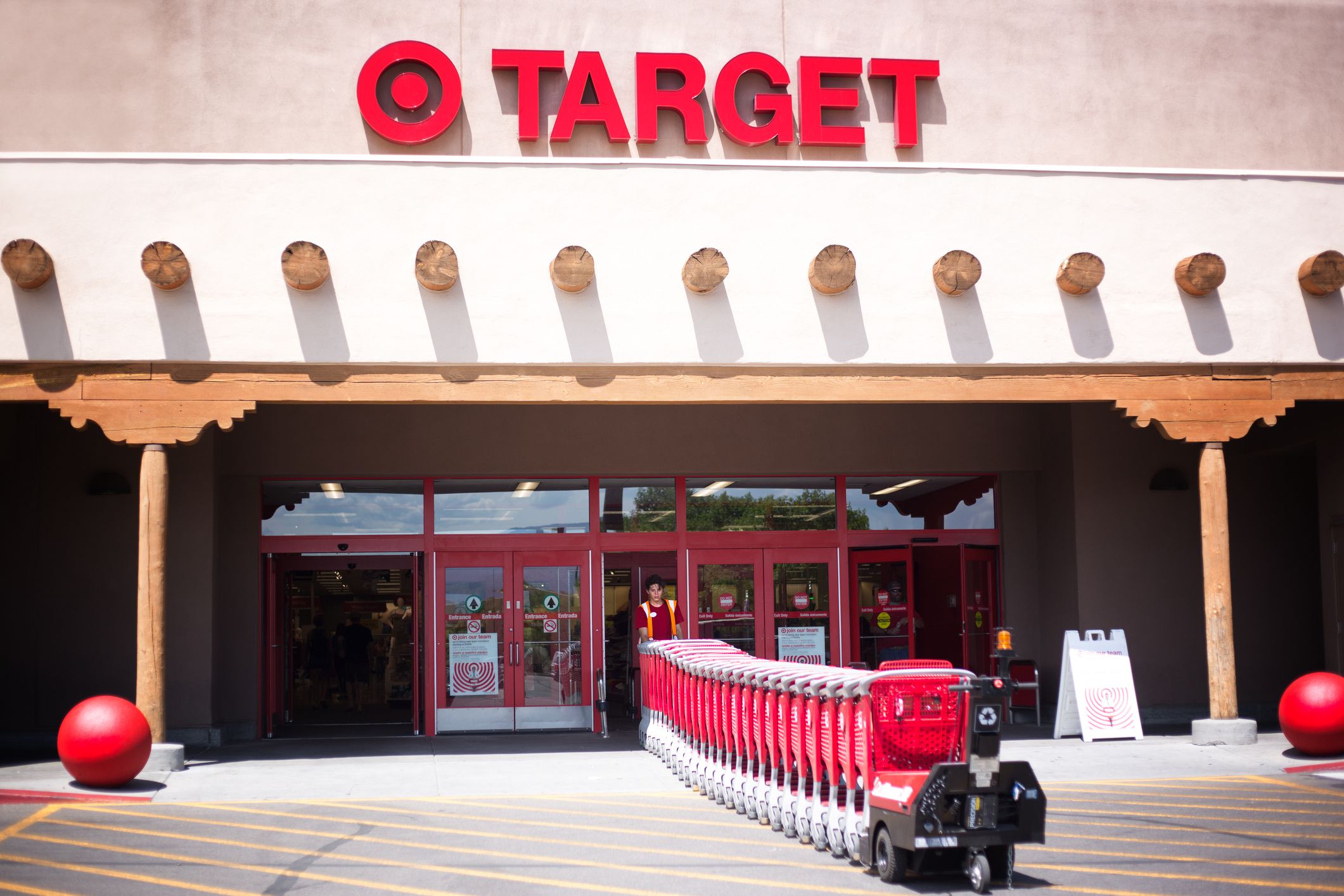 Santa Fe, NM: A Target employee pulls red shopping carts into the Santa Fe NM store. Santa Fe’s Target is constructed in the Southwest Pueblo architectural style.