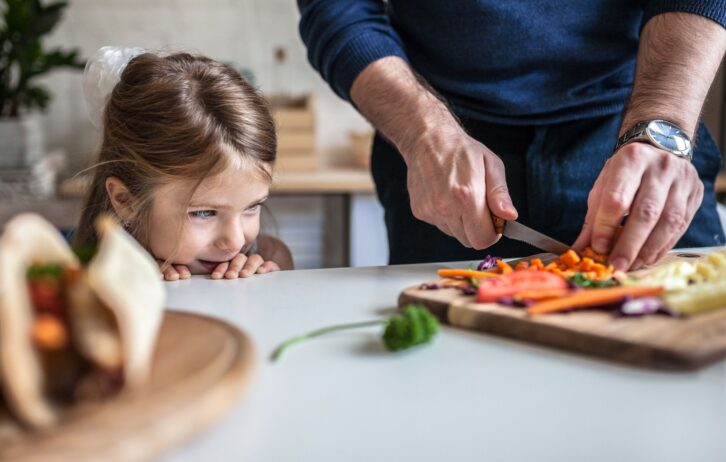 father and daughter in kitchen preparing to cook