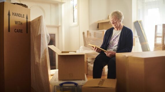 senior woman looks through some memories just before the house move begins