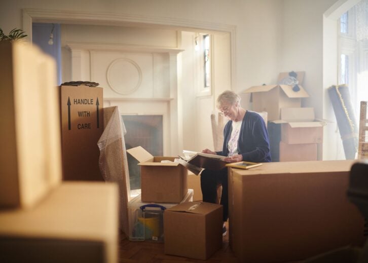 senior woman looks through some memories just before the house move begins