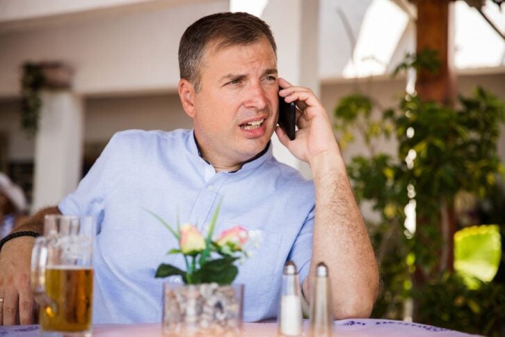 Rude man talking on his phone at a restaurant