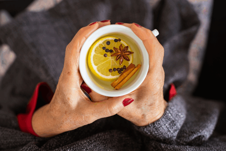 woman's hands holding cup of tea