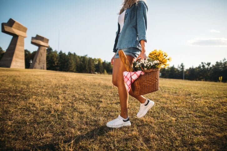 Young female hipster going on a picnic at a local park.