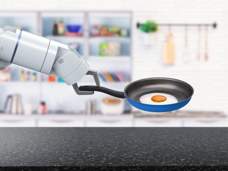 3d rendering chef robot hold frying pan in kitchen