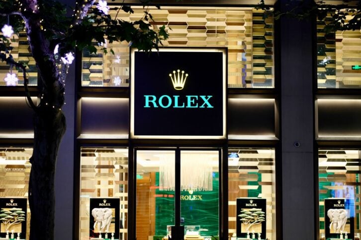 Shanghai/China-July 2019: front view of ROLEX store in Shanghai at night. Golden illuminated windows with shining brand logo in the center. A Swiss luxury watch manufacturer and popular in China.