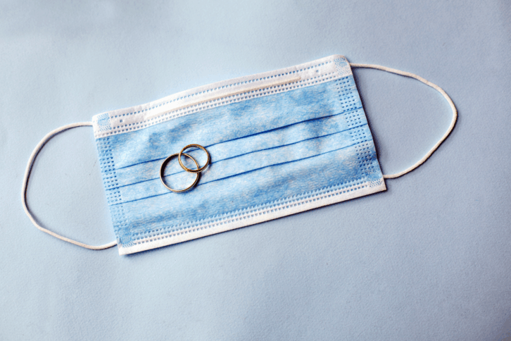 Wedding rings with surgical gloves.