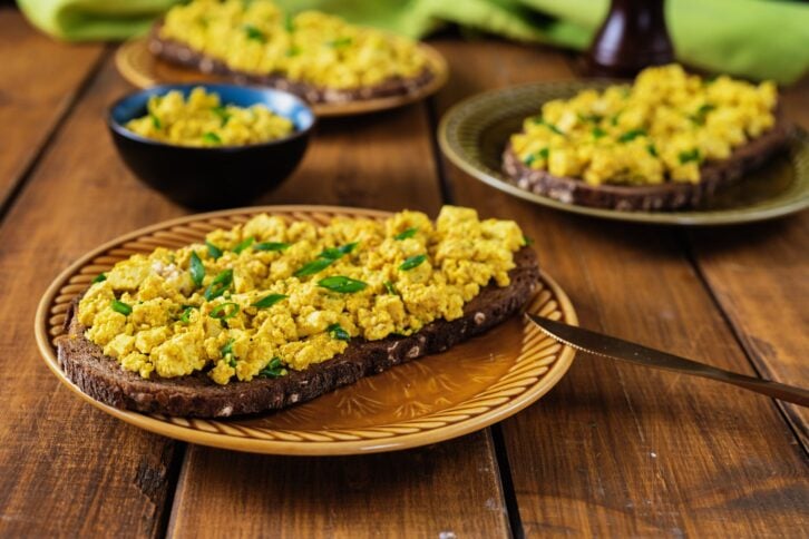 Close up of delicious vegan egg sandwiches on wooden rustic background