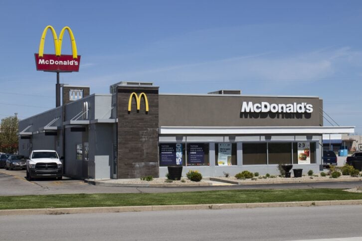 A photo of a McDonald's restaurant with a focus on the drive-thru lane