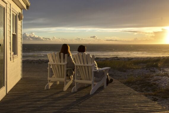 Romantic Couple Enjoying Sunset at Beach House