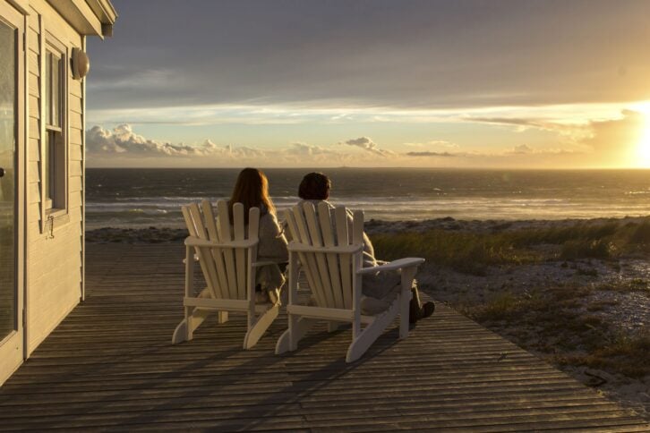 Romantic Couple Enjoying Sunset at Beach House