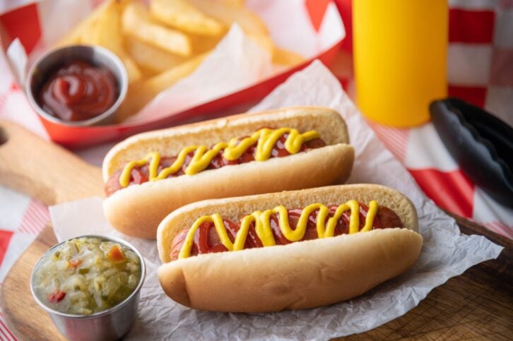 hot dog with french fries on red check table clothes