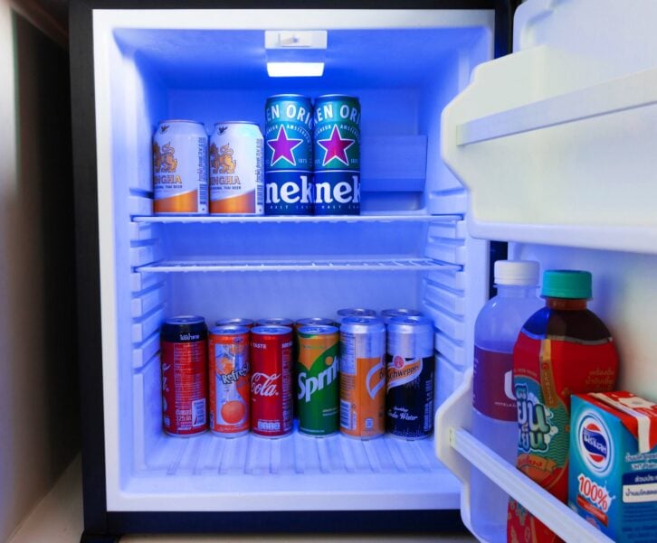 NAKHON RATCHASIMA, THAILAND-June 12,2020: cold soda and beer cans in mini fridge in hotel room.