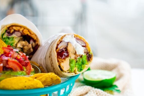 Mexican Burrito with tomato salad and guacamole dip