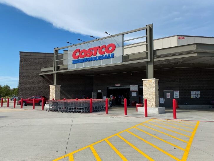 Mckinney, TX / USA - August 10, 2020: Costco Wholesale Entrance with shopping carts and customers in a sunny day