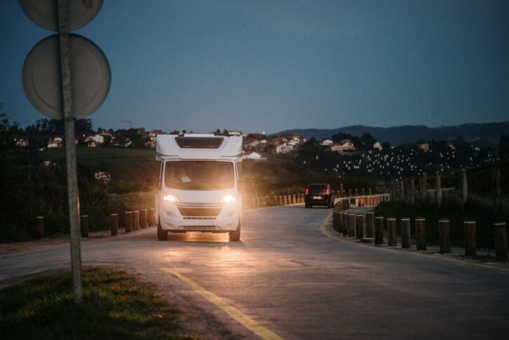 A modern motor home on a road at night