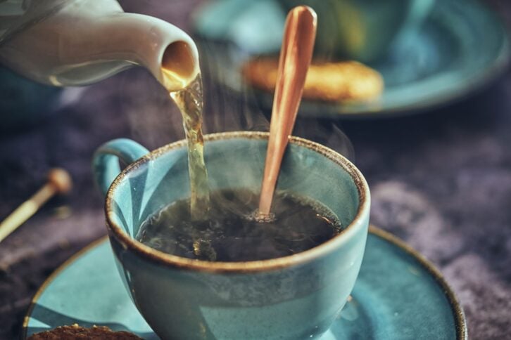 Cup of Black Tea Served with Biscuits