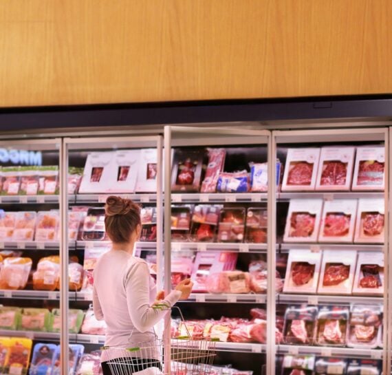 Woman choosing a dairy products at supermarket.