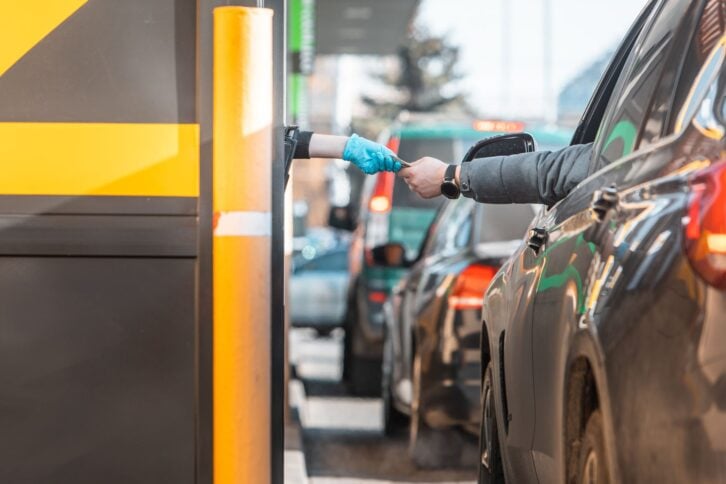 paying for fast food from the car at drive-through close up